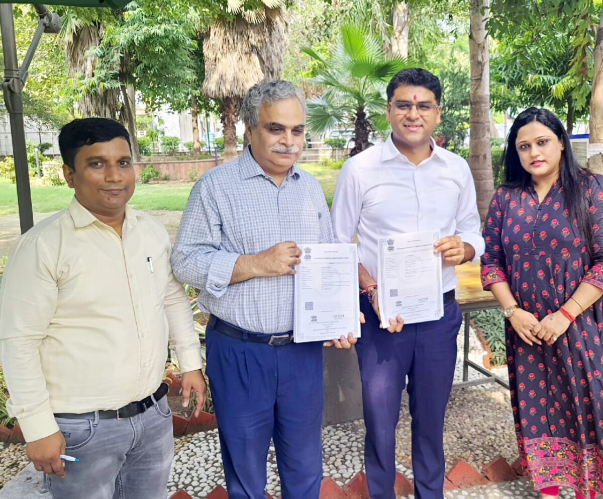 Dipendra Manocha holding the signed copy for MoU, with Arti chanana standing in left end and commissioner of Education Delhi standing beside Dipendra Manocha